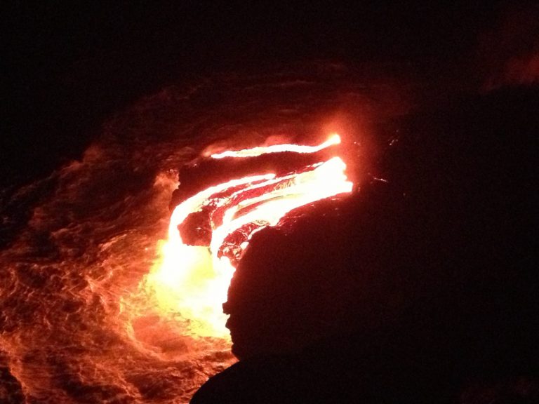 A curl of glowing pāhoehoe lava in the dark