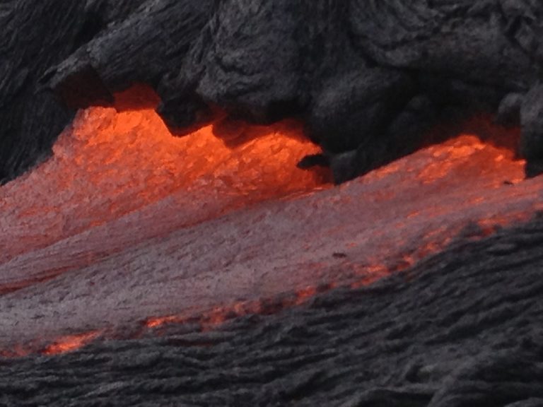 A slow tongue of lava crusting over in daylight