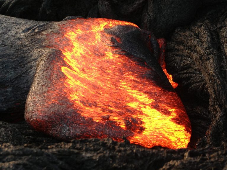 A thick lobe of lava glowing orange and yellow