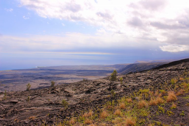 Old lava flows running down to the ocean under a big sky