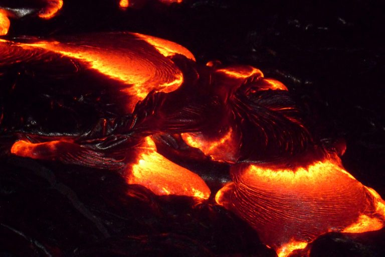 Molten lobes of pāhoehoe lava glowing at night